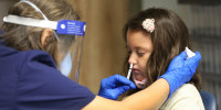 Ivy Kirschke, 7, receives the FluMist mist vaccine in Gainesville, Fla., in October.