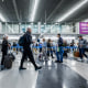Travelers walk through O'Hare International Airport in Chicago, Illinois, on Nov. 21, 2023. 